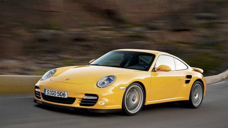 yellow porsche sports car