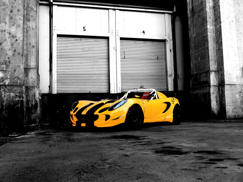 Yellow Race Car — Dramatic, Photograph, Garage Doors