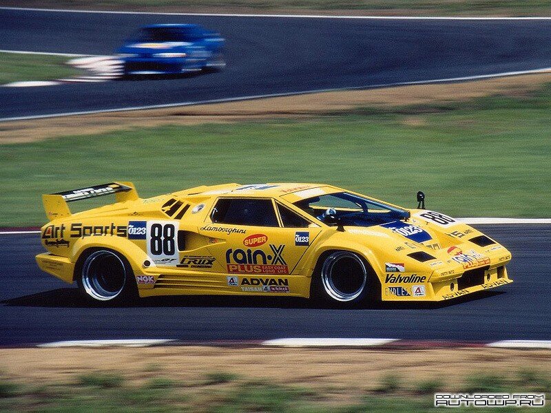Yellow Race Car — Dynamic, Afternoon, Photograph, Race Track, Blue Car