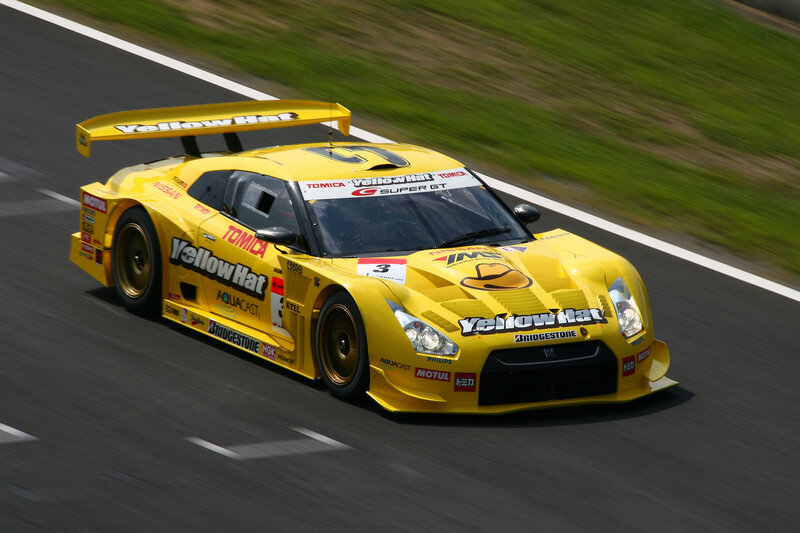 Yellow Race Car — Dynamic, Afternoon, Photograph, Race Track, Green Grass
