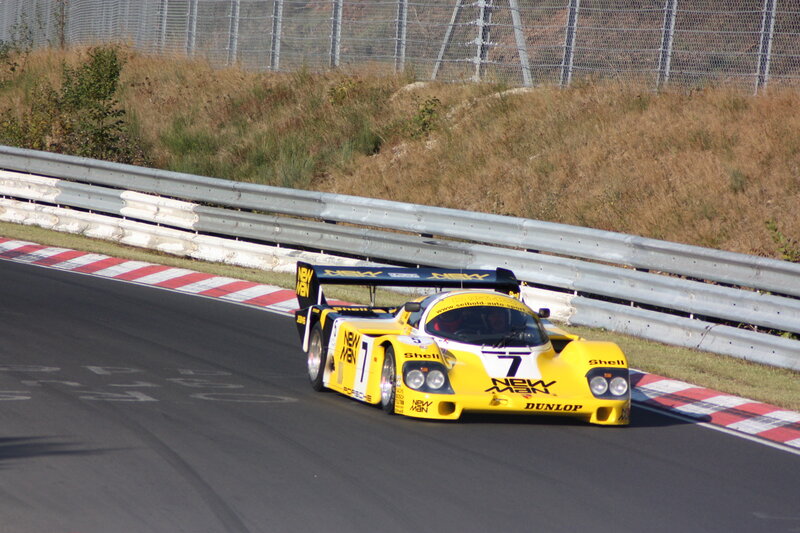 Yellow Race Car — Dynamic, Afternoon, Photograph, Race Track, Guardrail