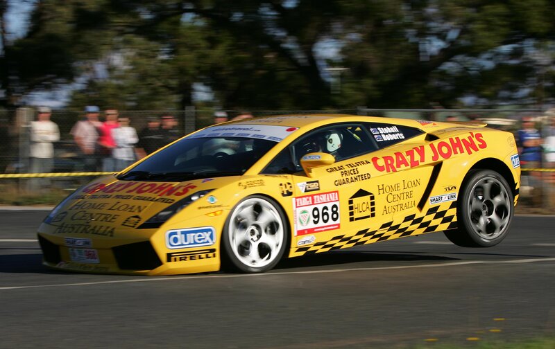 Yellow Race Car — Dynamic, Afternoon, Photograph, Race Track, Spectators