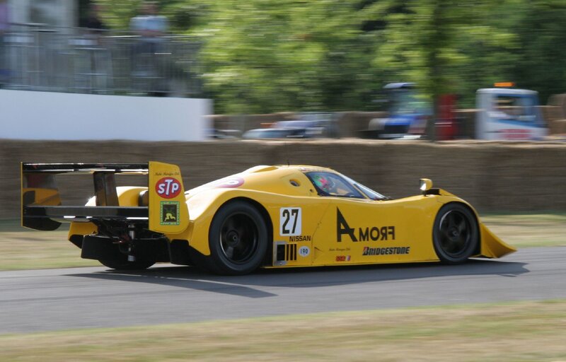 Yellow Race Car — Dynamic, Afternoon, Photograph, Race Track, Trees, Spectators