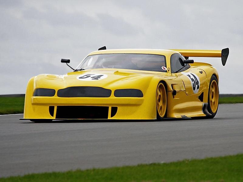 Yellow Race Car — Dynamic, Photograph, Race Track, Grass, Sky