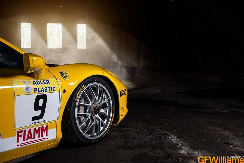 Yellow race car in a dark garage