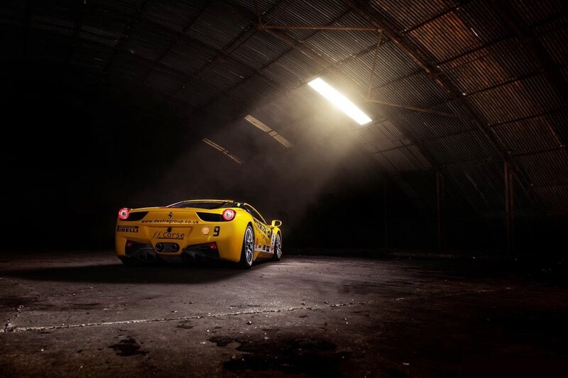 Yellow race car in a dark garage