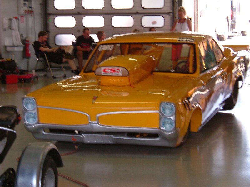 Yellow race car in garage