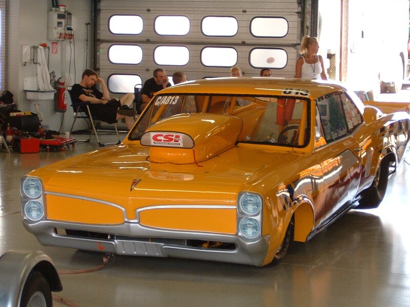 Yellow race car in garage