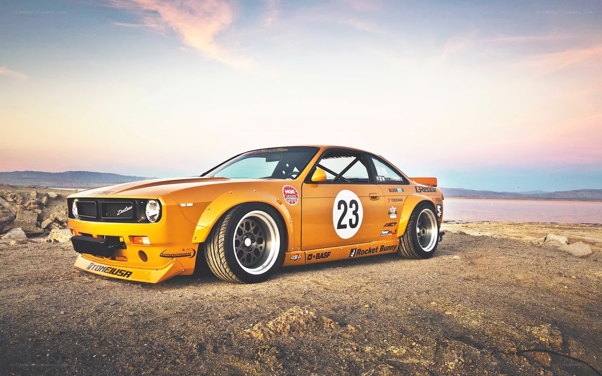 Yellow race car on beach