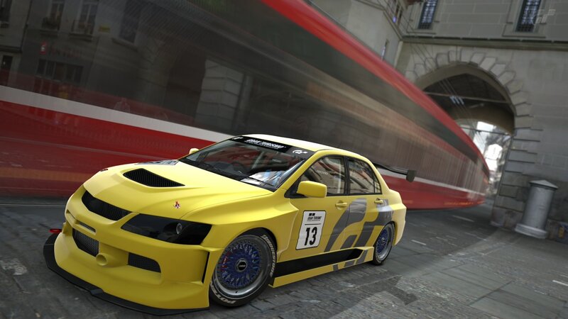 yellow race car on city street