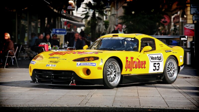 Yellow race car on city street