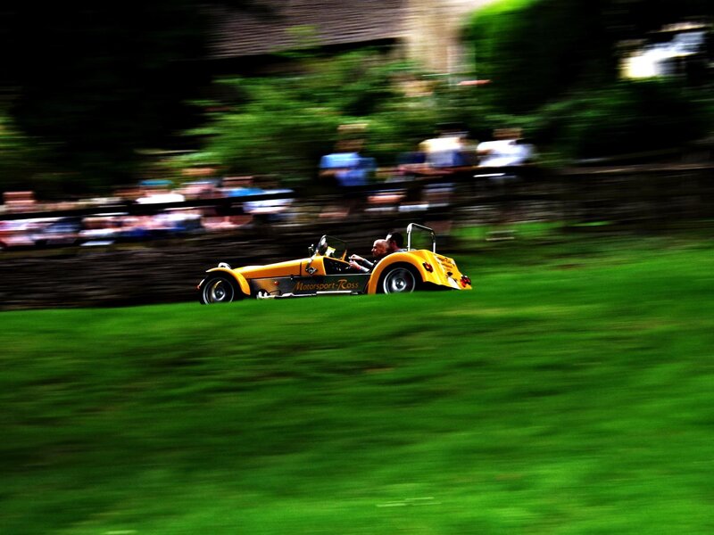 Yellow race car on grass