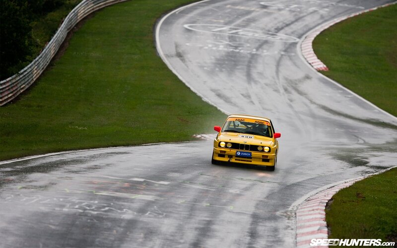 Yellow race car on wet track