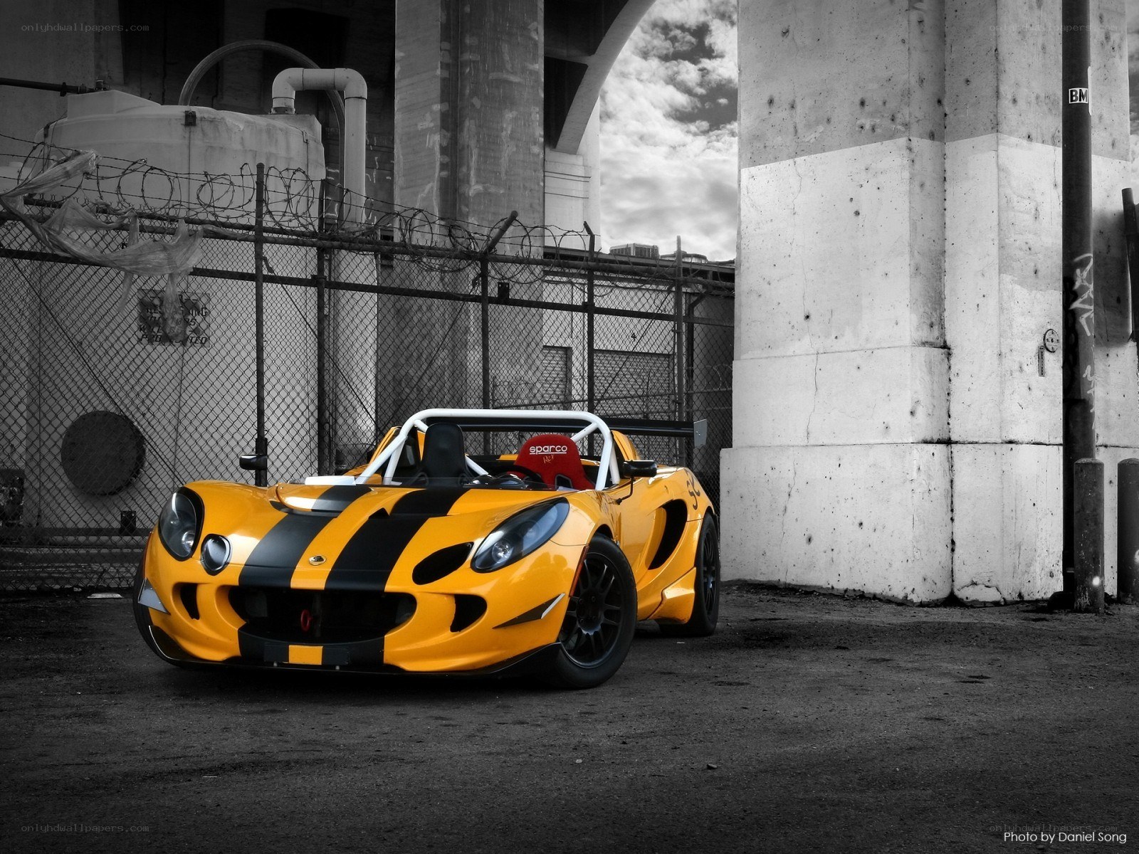 Yellow race car under bridge
