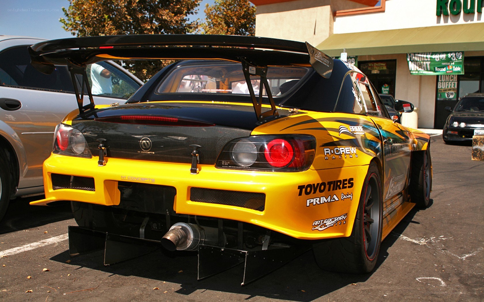 yellow race car with large spoiler