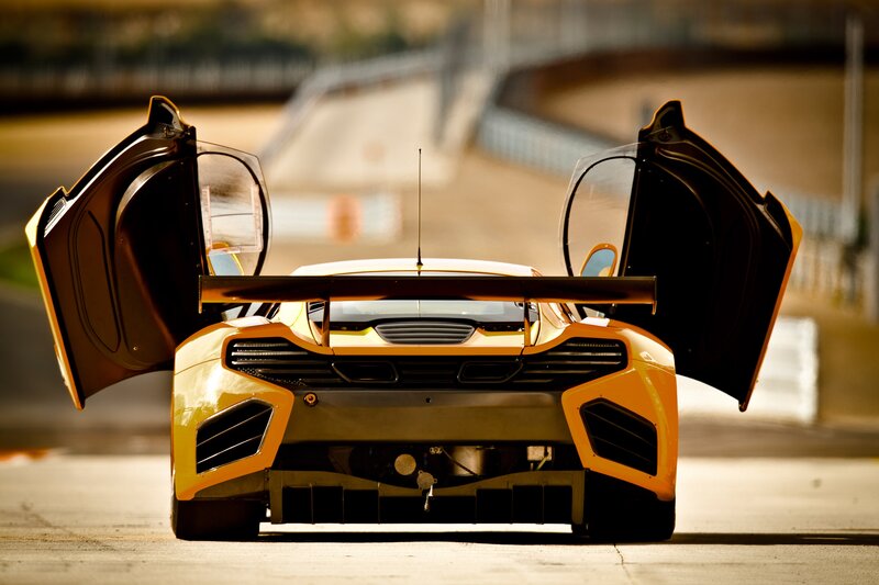 Yellow race car with open doors