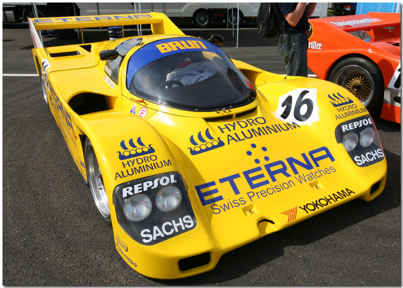 Yellow race car with sponsor logos