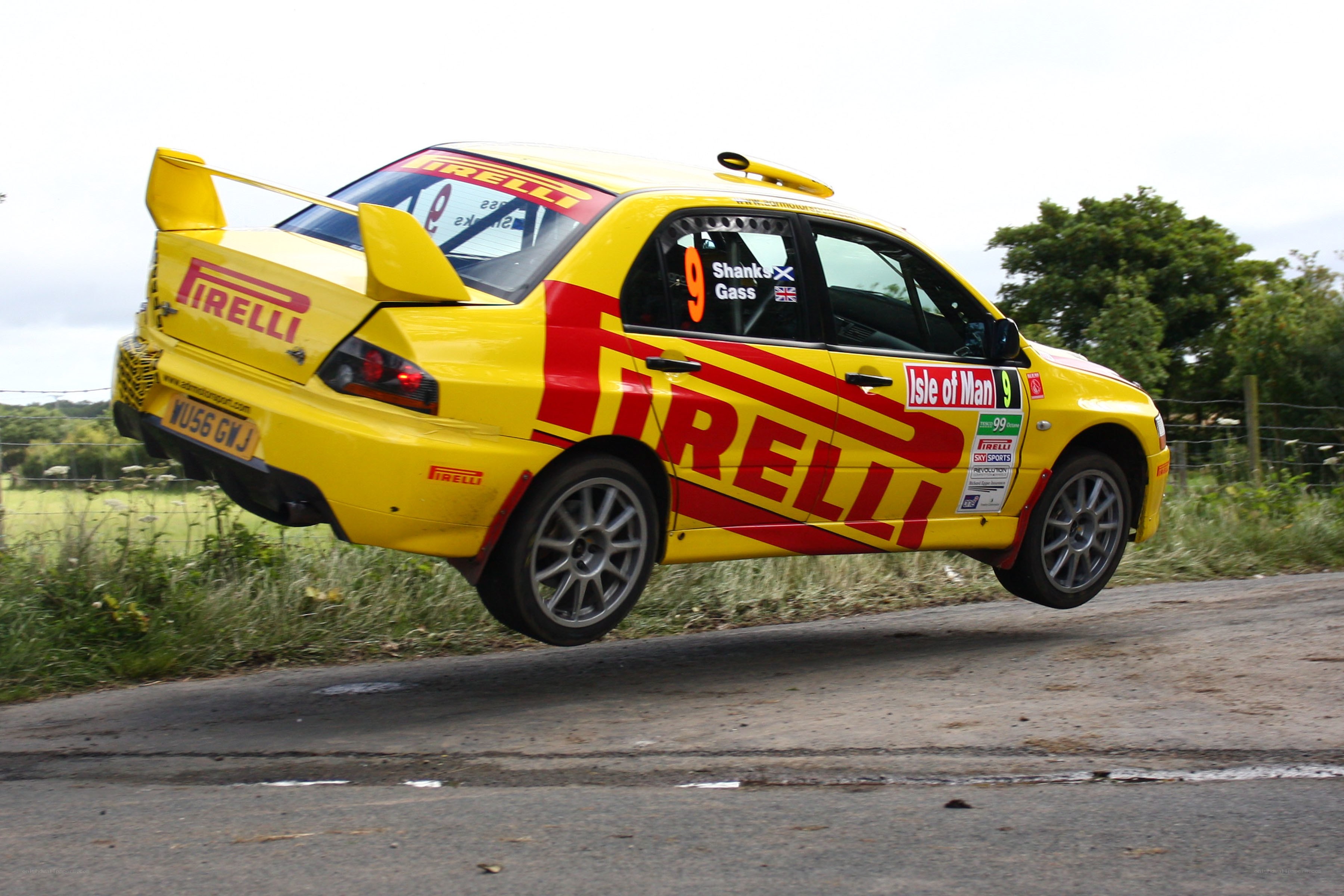 Yellow rally car in mid-air
