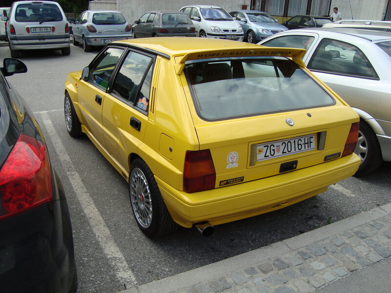 Yellow rally car in parking lot