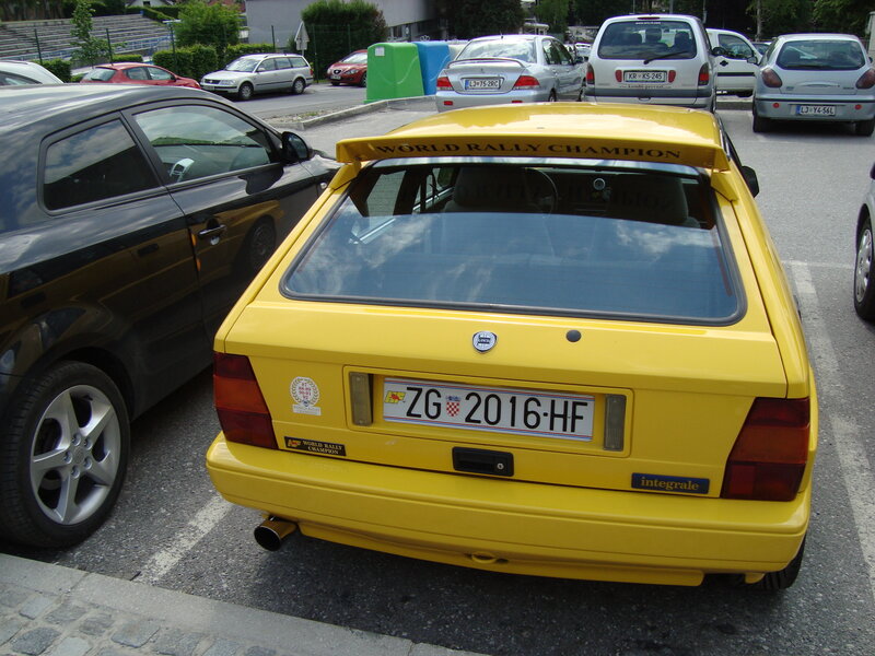 Yellow rally car in parking lot