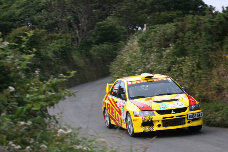 Yellow rally car on a road