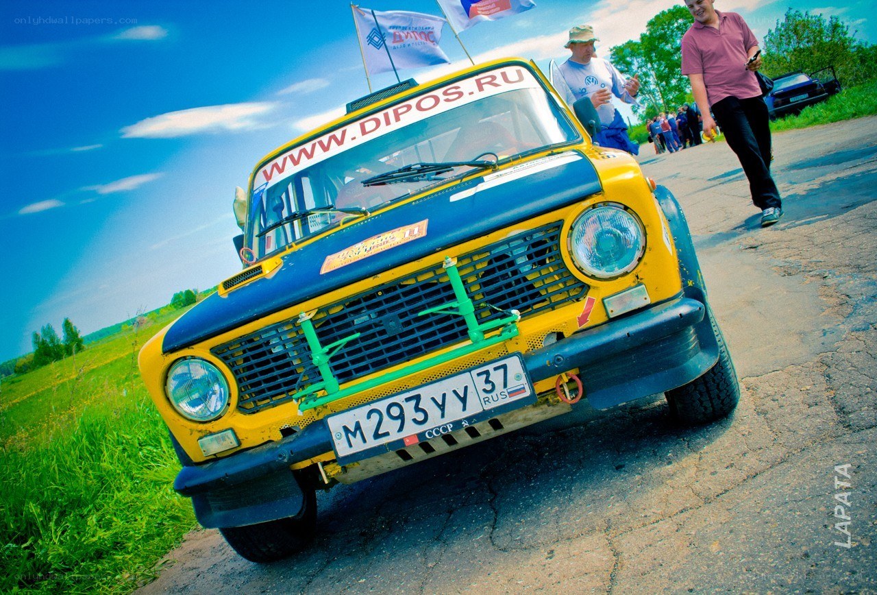Yellow rally car on a road