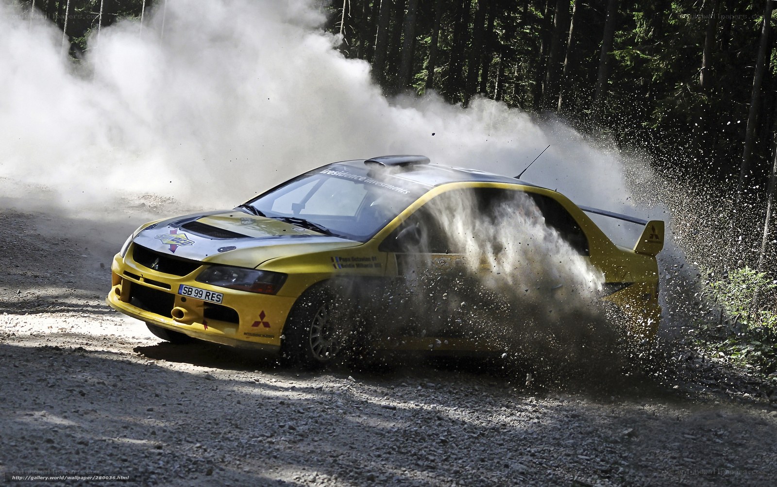 Yellow rally car on dirt road