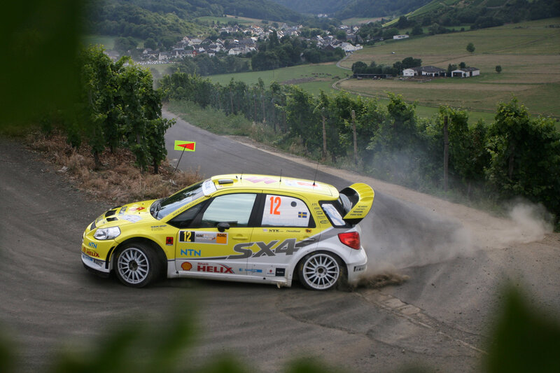 Yellow rally car on dirt road