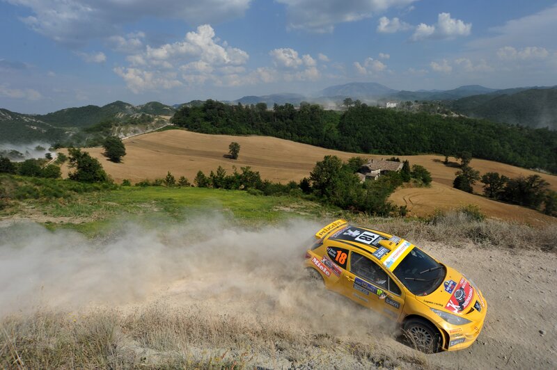 Yellow rally car on dirt road