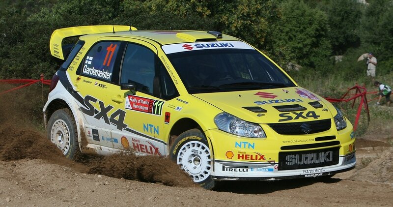 Yellow rally car on dirt track
