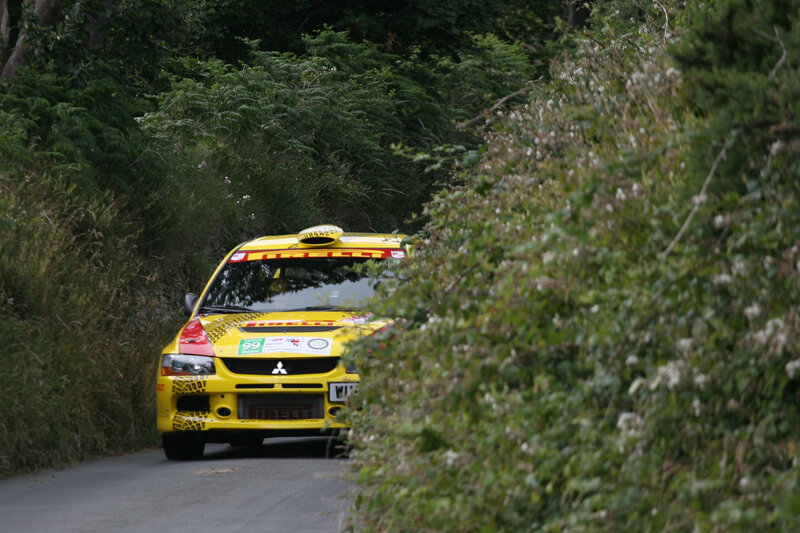 Yellow rally car on forest road