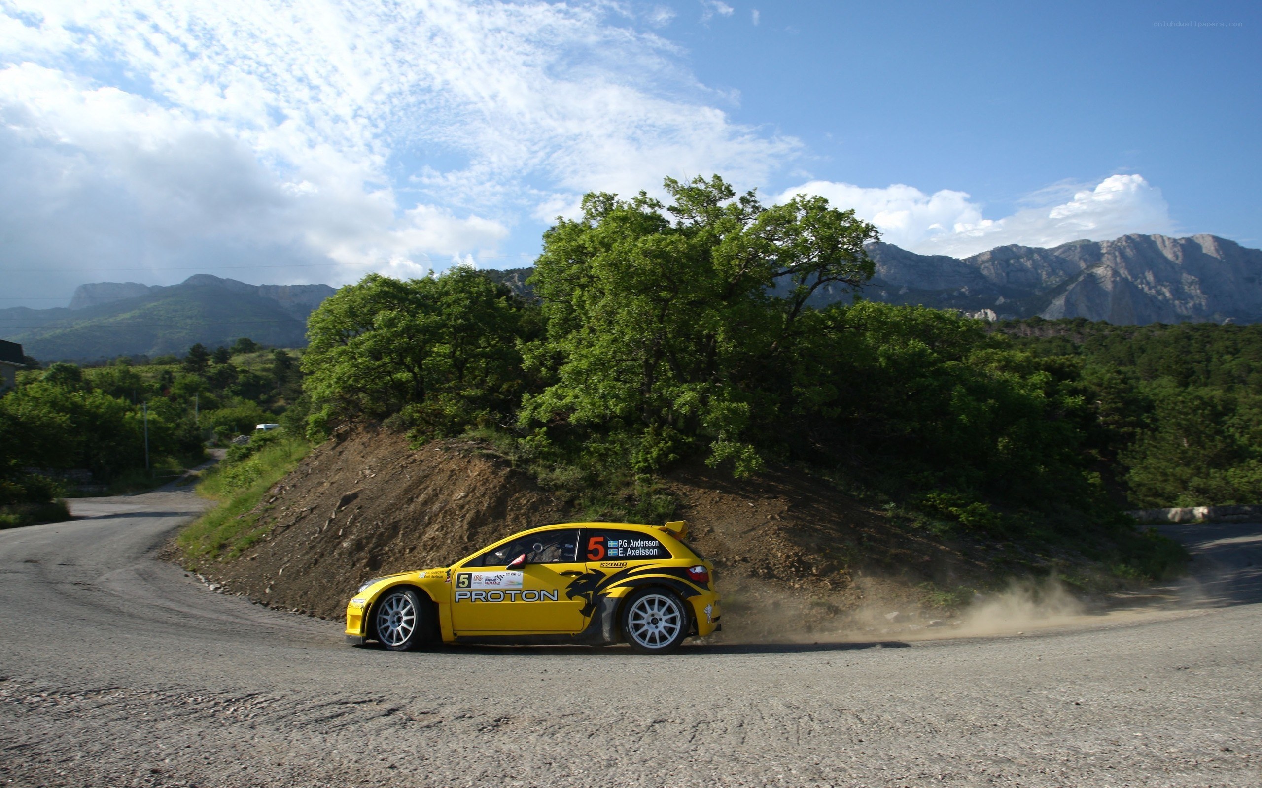 Yellow rally car on mountain road
