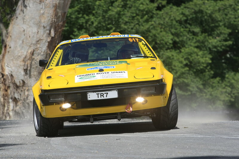 Yellow rally car on road