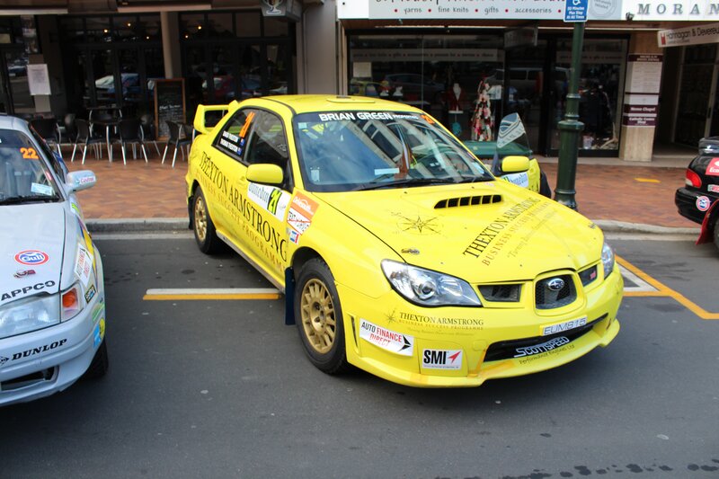 Yellow rally car on street