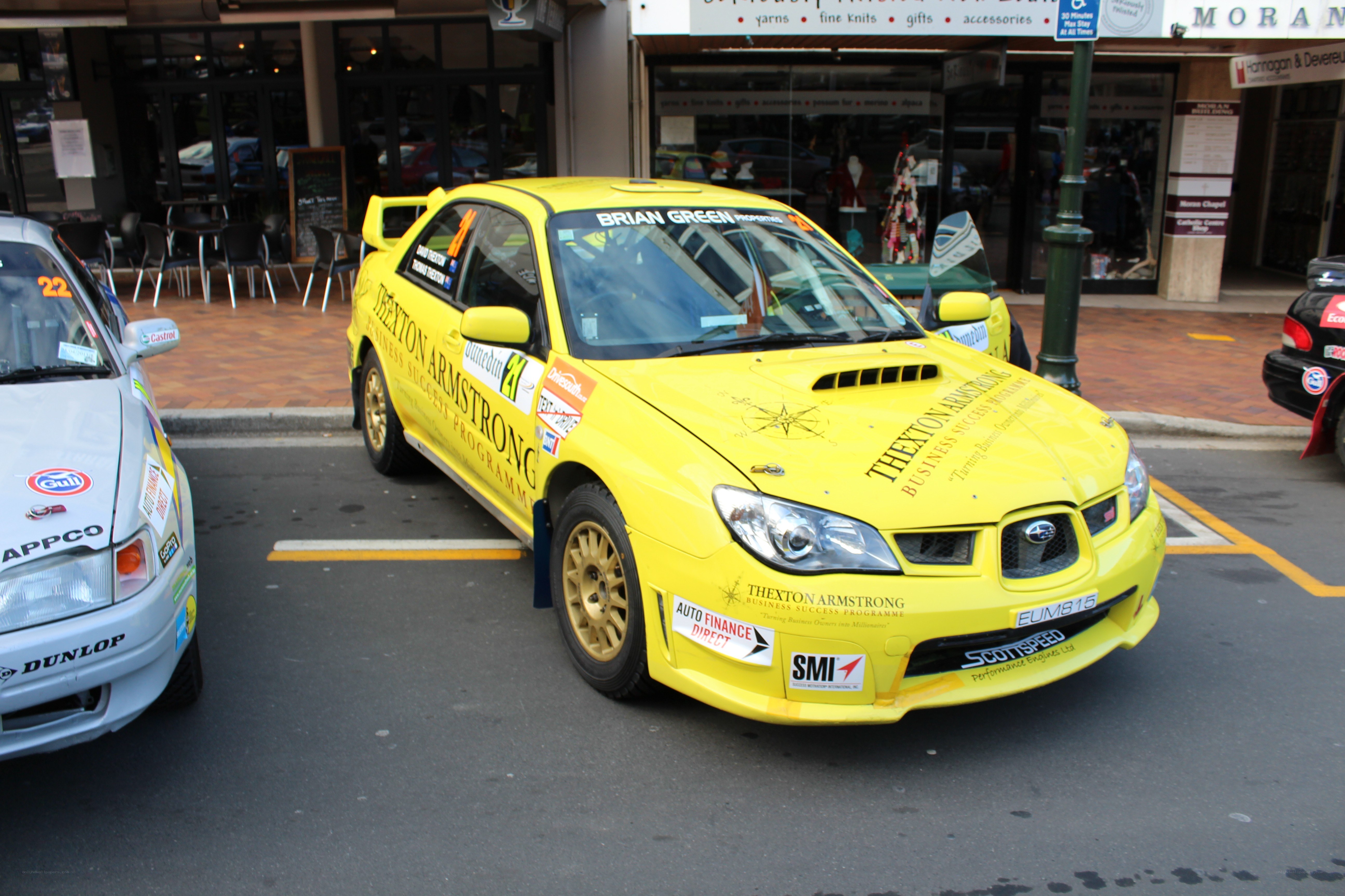 Yellow rally car on street