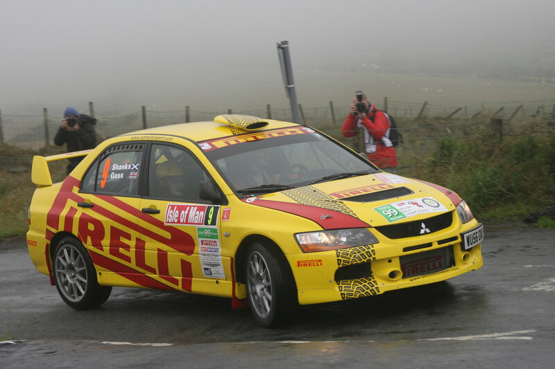 Yellow rally car on wet road