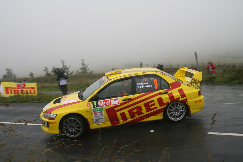 Yellow rally car on wet road