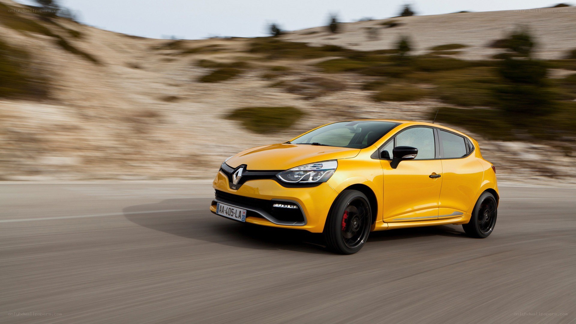 Yellow Renault Clio in motion