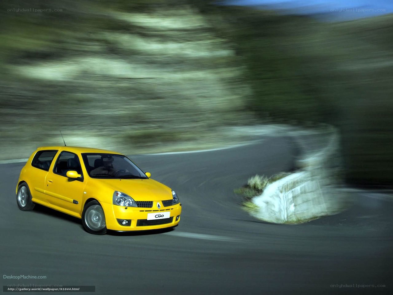 Yellow Renault Clio on a winding road