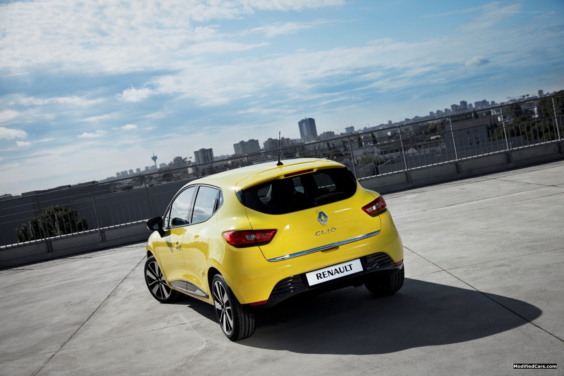 Yellow Renault Clio on rooftop