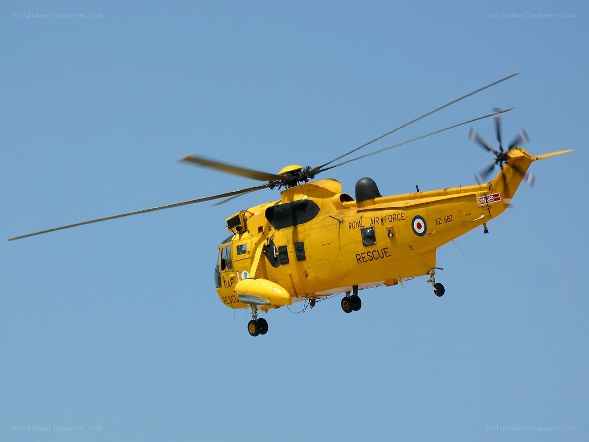 Yellow rescue helicopter in flight