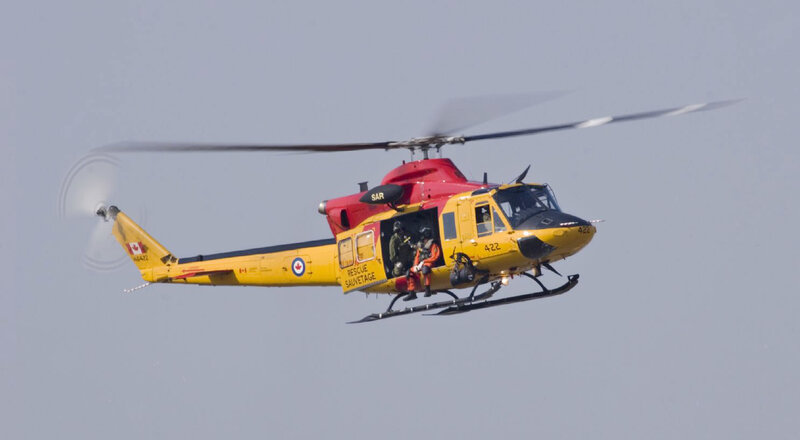 Yellow rescue helicopter in flight