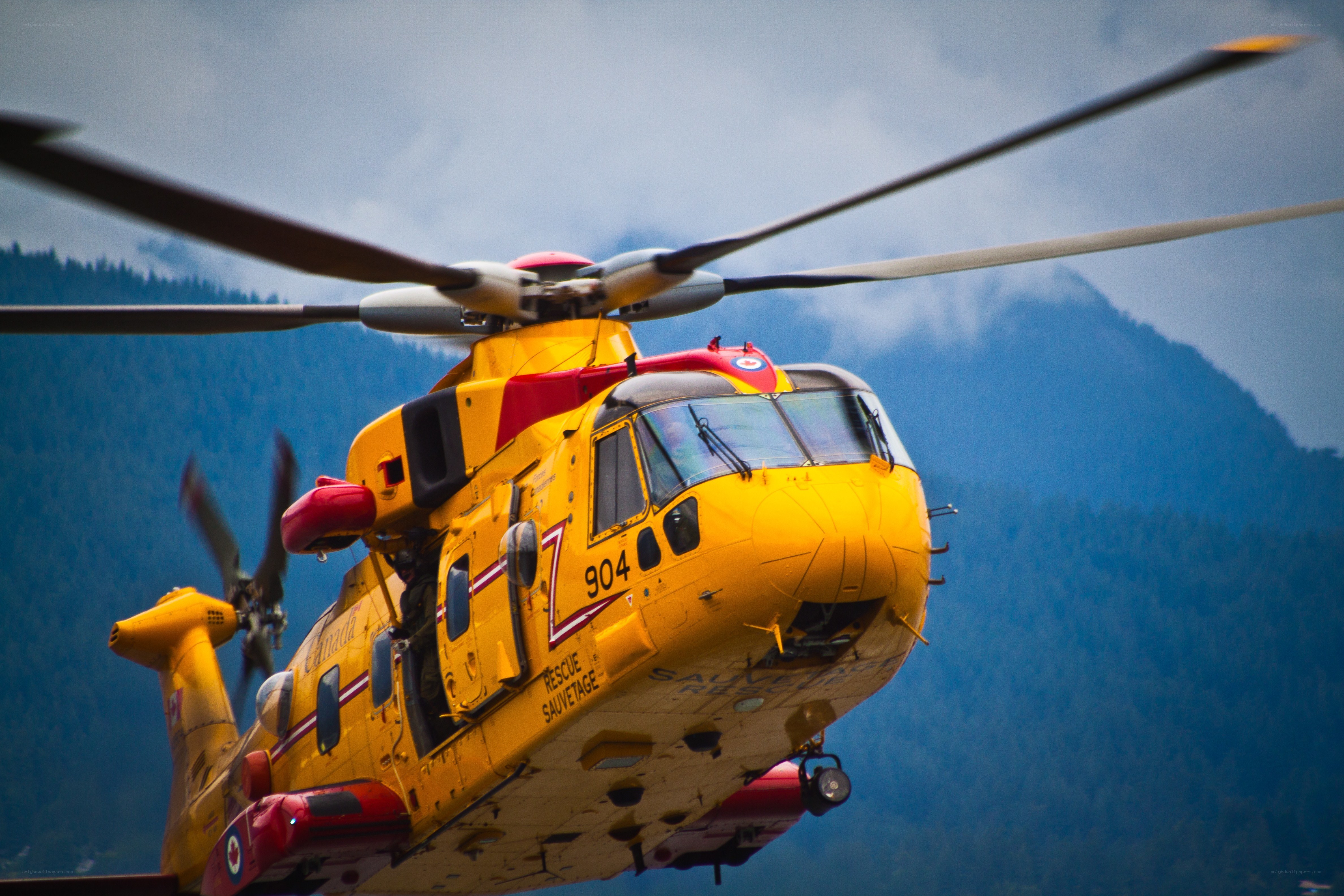 Yellow rescue helicopter in flight