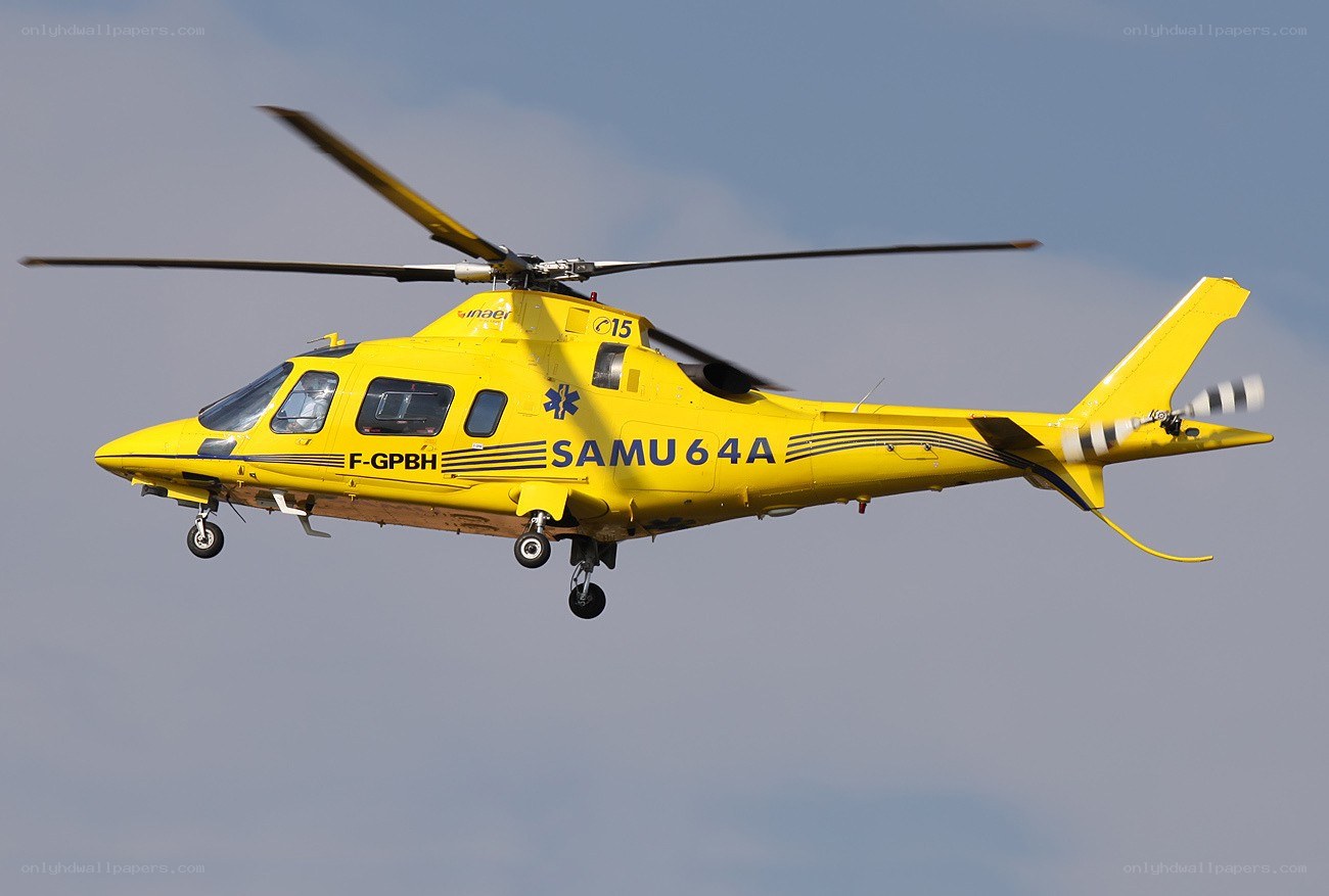 Yellow rescue helicopter in flight