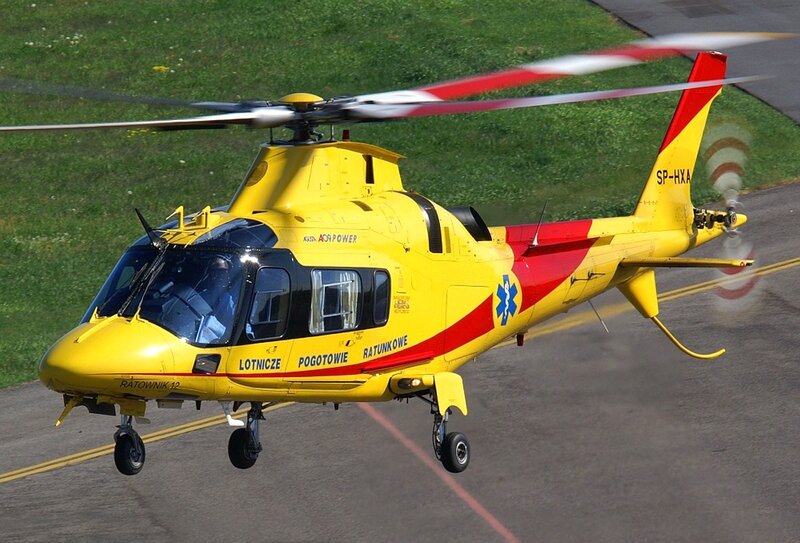 Yellow rescue helicopter in flight