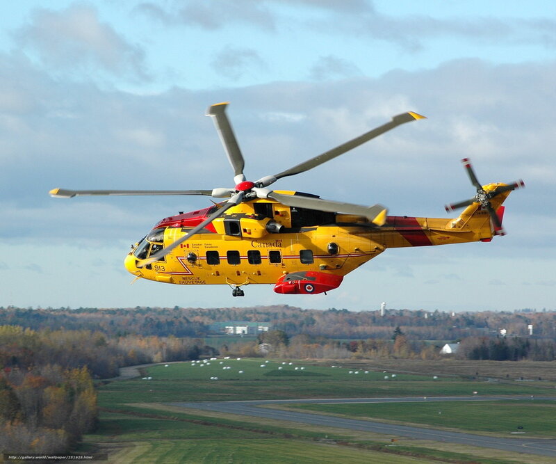Yellow rescue helicopter in flight
