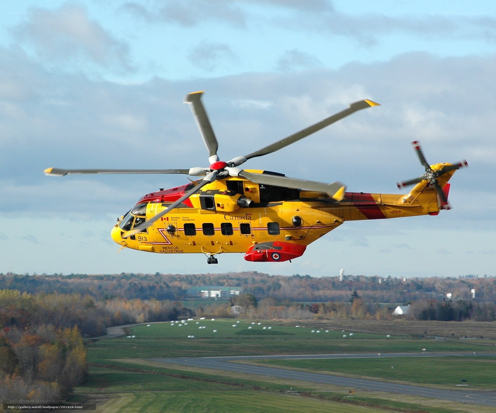 Yellow rescue helicopter in flight