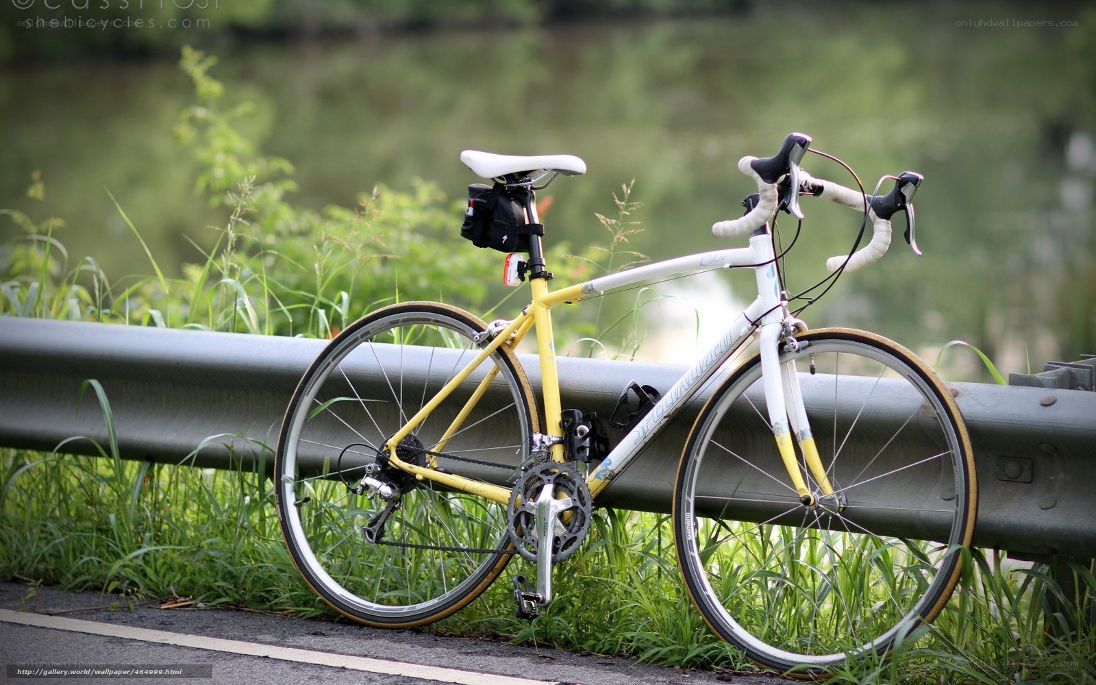 yellow road bike on guardrail
