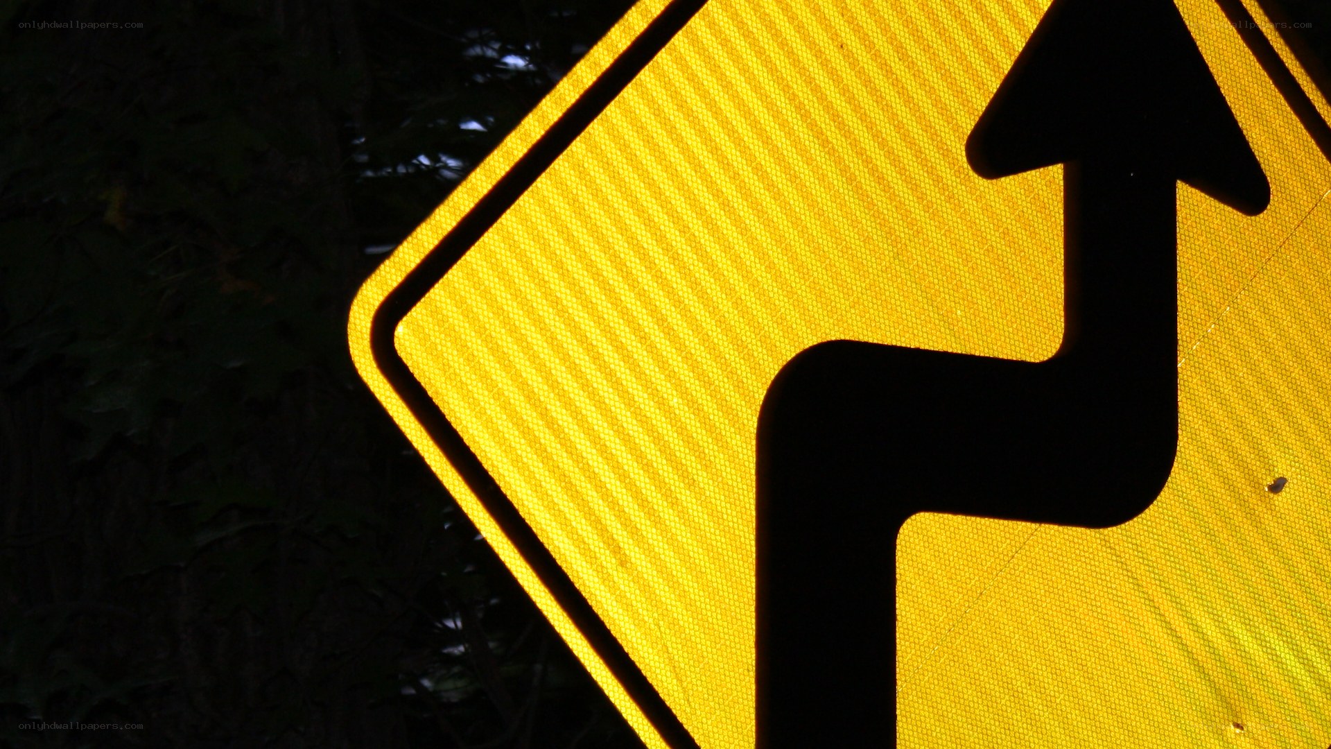 yellow road sign with arrow