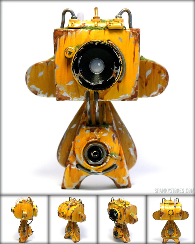 yellow robot camera sculpture